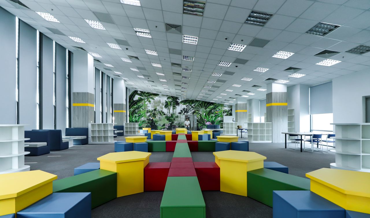 Spacious modern educational area with vibrant furniture in a well-lit environment.